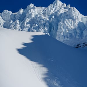 Snow covered rime ice towers under blue winter sky