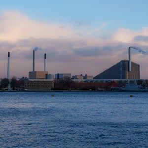 Industrial harbor waterfront with chimneys at dusk