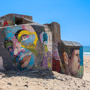 Colorful graffiti covered bunker on a sunny beach