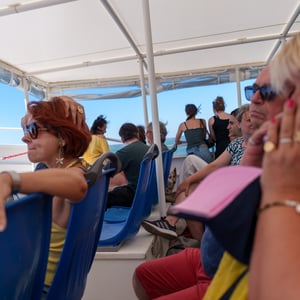 Passengers on a sunny open deck boat ride