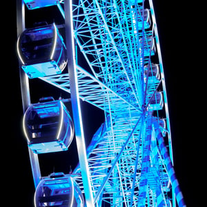 Blue lit Ferris wheel at night