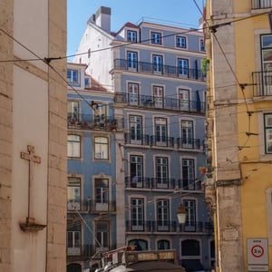 Lisbon tram 28 on a sunlit cobbled street