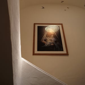 Mother cradling sleeping baby under glowing veil portrait
