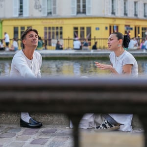 Two friends chatting by a canal in Paris
