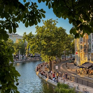 People relaxing by a canal at golden hour in Paris