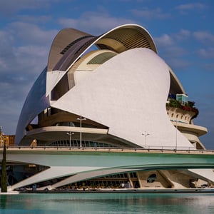 Curved white opera house over turquoise water in Valencia
